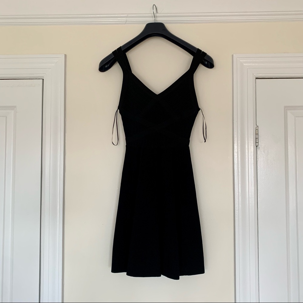 Never worn. Herve Leger couture “bandage” style black mini dress by Guess.